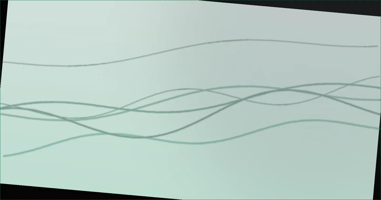 A desk monitor with a soft white glow on the wall behind it in a dim room