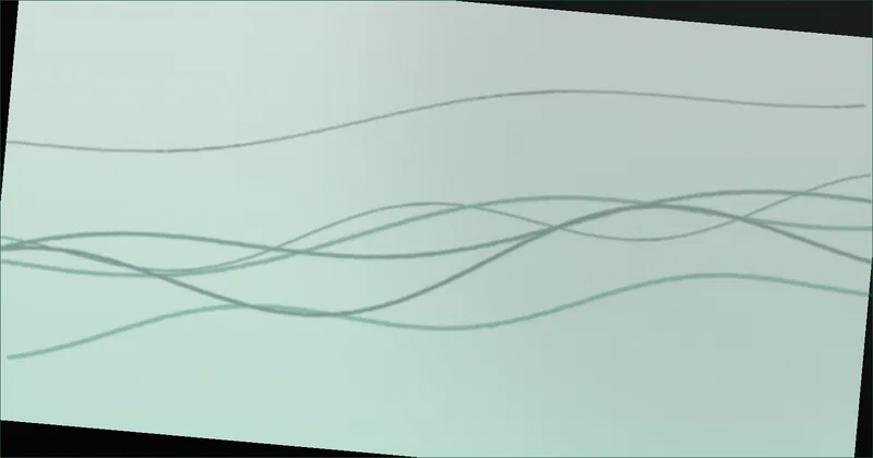 A desk monitor with a soft white glow on the wall behind it in a dim room